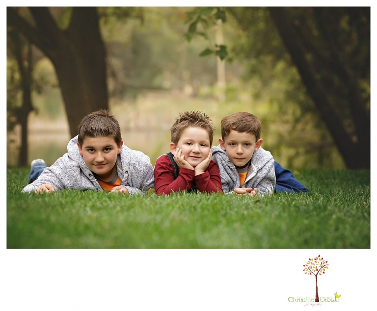 Sonora family photographer Christine Dibble Photography takes family portraits in Angels Camp of a family with three boys on private property with olive trees and a pond.