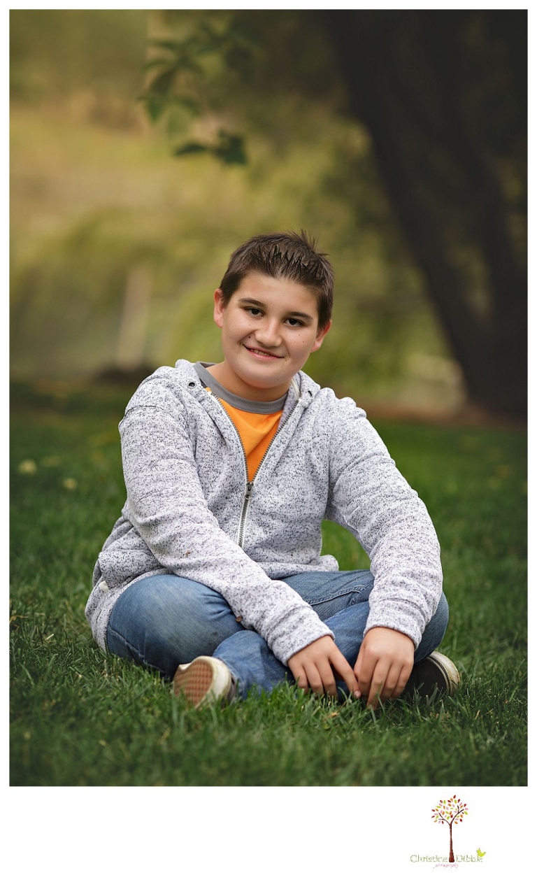 Sonora family photographer Christine Dibble Photography takes family portraits in Angels Camp of a family with three boys on private property with olive trees and a pond.