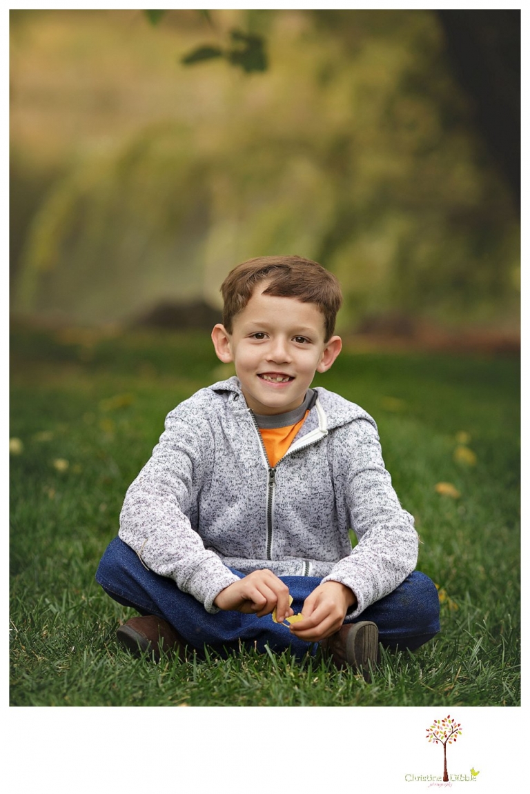 Sonora family photographer Christine Dibble Photography takes family portraits in Angels Camp of a family with three boys on private property with olive trees and a pond.