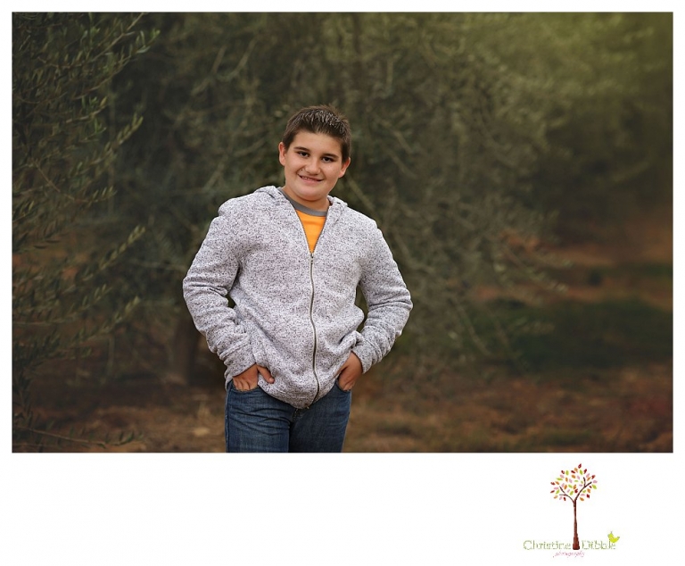 Sonora family photographer Christine Dibble Photography takes family portraits in Angels Camp of a family with three boys on private property with olive trees and a pond.
