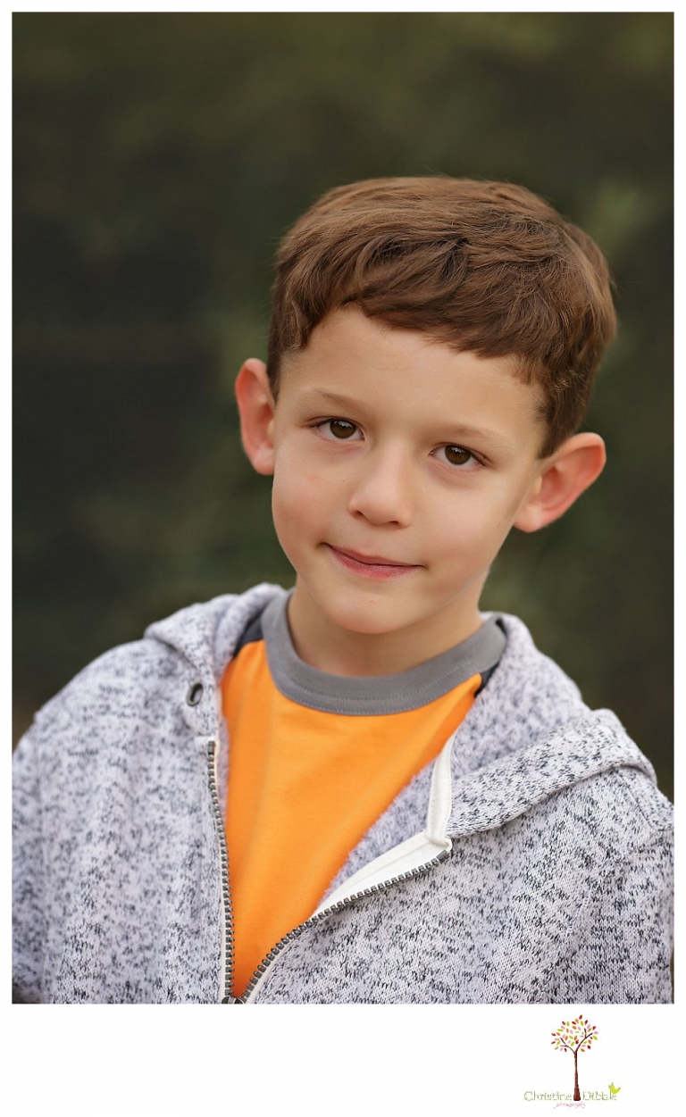 Sonora family photographer Christine Dibble Photography takes family portraits in Angels Camp of a family with three boys on private property with olive trees and a pond.