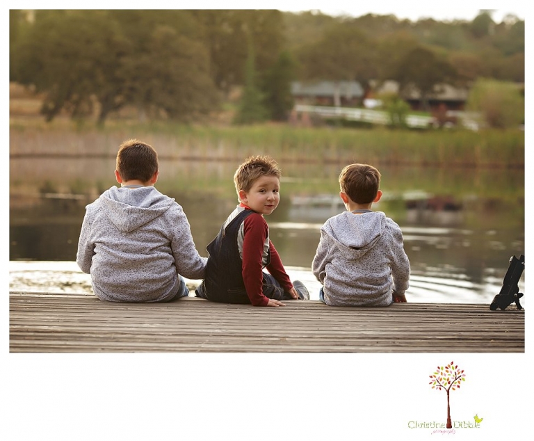 Sonora family photographer Christine Dibble Photography takes family portraits in Angels Camp of a family with three boys on private property with olive trees and a pond.
