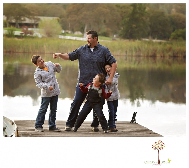 Sonora family photographer Christine Dibble Photography takes family portraits in Angels Camp of a family with three boys on private property with olive trees and a pond.