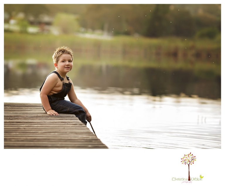 Sonora family photographer Christine Dibble Photography takes family portraits in Angels Camp of a family with three boys on private property with olive trees and a pond.