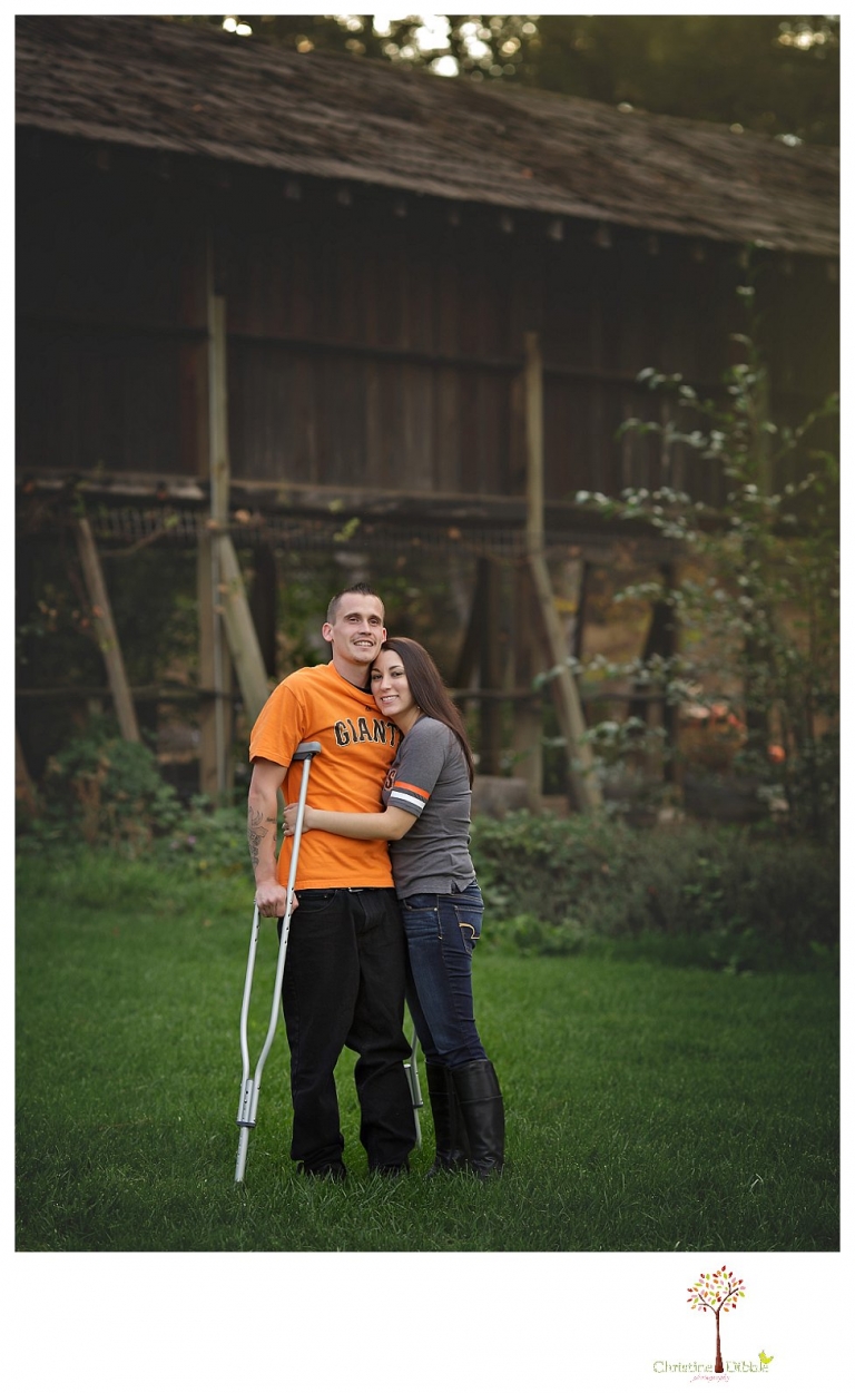 Sonora engagement and wedding photographer Christine Dibble Photography takes engagement photos of a couple while the groom is on crutches for a broken foot and they both wear San Francisco Giants baseball shirts.