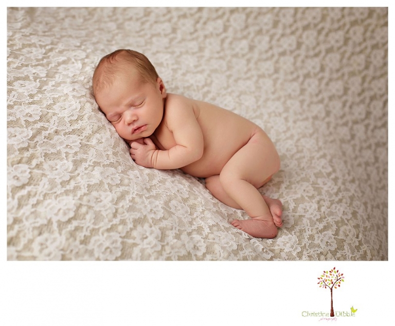 Best Sonora Newborn Photographer Christine Dibble Photography takes portraits of a sleeping newborn on blankets, in wraps and props, and on her mother's wedding dress.