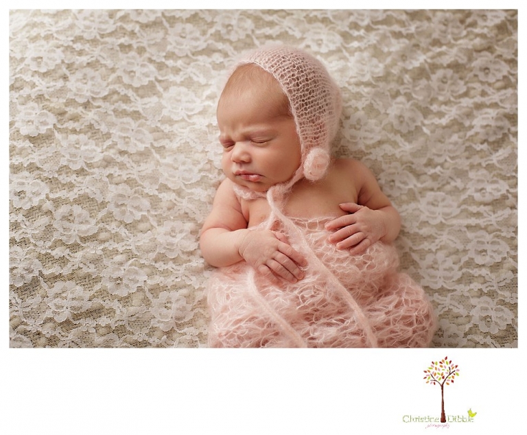 Best Sonora Newborn Photographer Christine Dibble Photography takes portraits of a sleeping newborn on blankets, in wraps and props, and on her mother's wedding dress.
