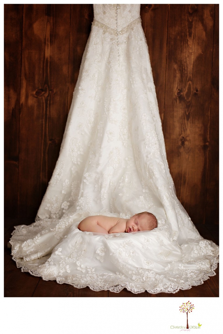 Best Sonora Newborn Photographer Christine Dibble Photography takes portraits of a sleeping newborn on blankets, in wraps and props, and on her mother's wedding dress.