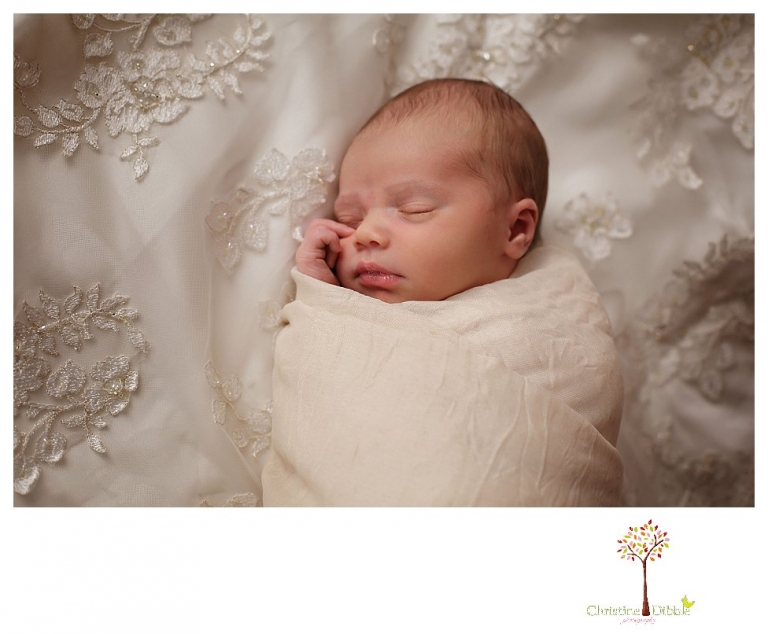 Best Sonora Newborn Photographer Christine Dibble Photography takes portraits of a sleeping newborn on blankets, in wraps and props, and on her mother's wedding dress.