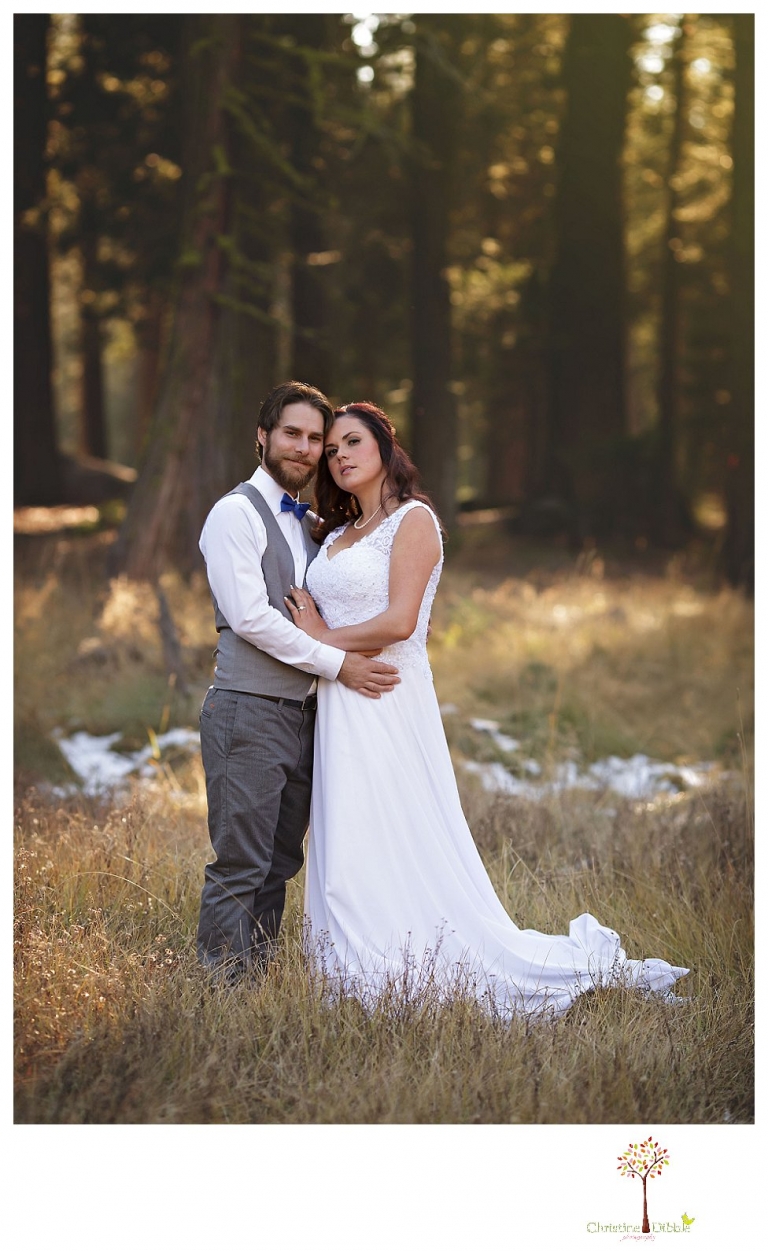 Sonora and Pinecrest wedding photographer Christine Dibble Photography takes wedding photos at a Pinecrest elopement including the couple in a field dotted with snow.