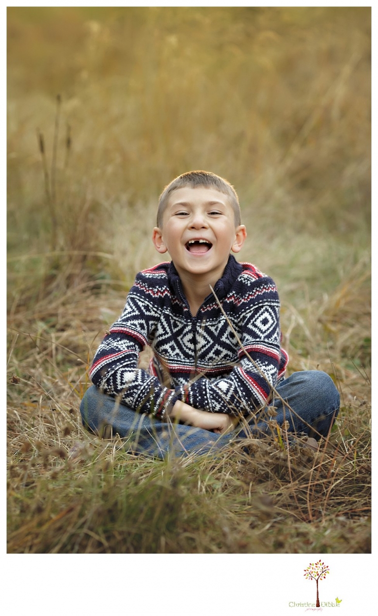 Sonora family photographer Christine Dibble Photography takes family portraits at Pinecrest Lake as the family plays in a field and then wears ugly sweaters for Christmas card photos.