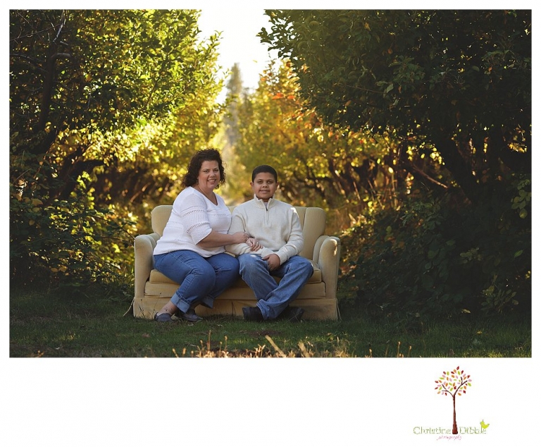Sonora Family Photographer Christine Dibble Photography takes extended Fall family photos at Indigeny Reserve on a cream velvet loveseat sitting in the apple orchard.