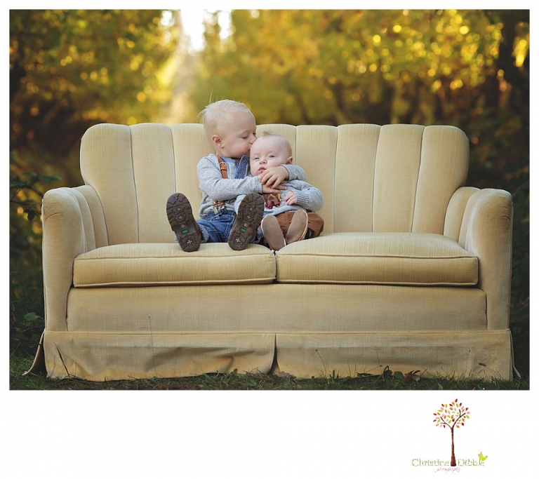 Sonora Family Photographer Christine Dibble Photography takes extended Fall family photos at Indigeny Reserve on a cream velvet loveseat sitting in the apple orchard.