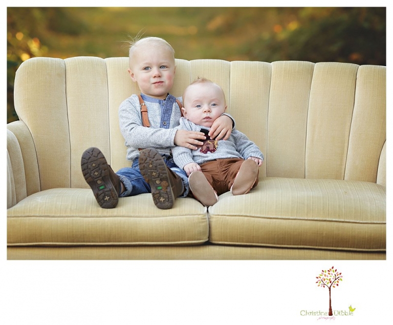 Sonora Family Photographer Christine Dibble Photography takes extended Fall family photos at Indigeny Reserve on a cream velvet loveseat sitting in the apple orchard.