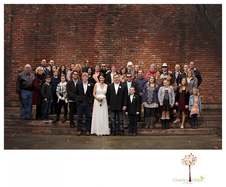 Sonora Wedding Photographer Christine Dibble Photography takes wedding portraits at an outdoor winter rainy wedding at the Tuolumne County Museum courtyard and Emberz restaurant.