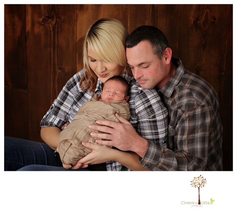 Sonora Newborn Photographer Christine Dibble Photography takes newborn portraits with a hunting camoflage theme including trophy antlers, a vintage wooden shot box and furs.