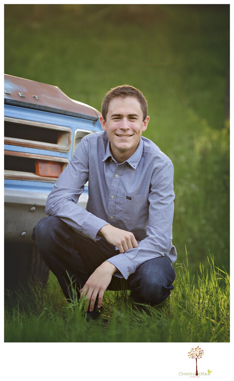 Sonora High senior portrait photographer Christine Dibble Photography takes outdoor spring senior portraits of a track star in his yard with his letterman jacket and old Chevy truck.