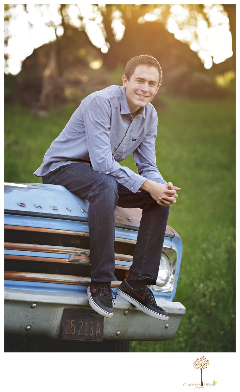 Sonora High senior portrait photographer Christine Dibble Photography takes outdoor spring senior portraits of a track star in his yard with his letterman jacket and old Chevy truck.