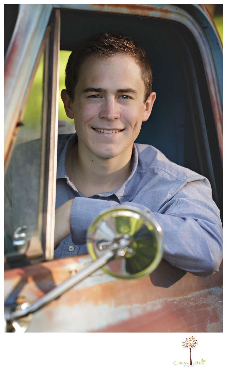 Sonora High senior portrait photographer Christine Dibble Photography takes outdoor spring senior portraits of a track star in his yard with his letterman jacket and old Chevy truck.