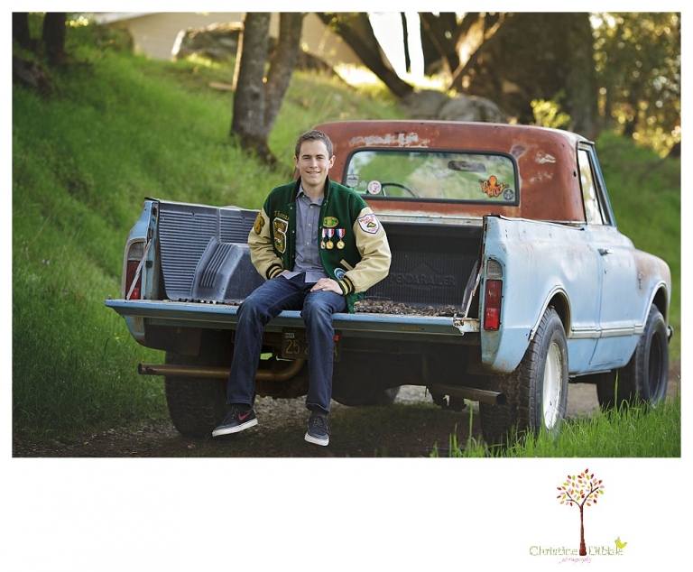 Sonora High senior portrait photographer Christine Dibble Photography takes outdoor spring senior portraits of a track star in his yard with his letterman jacket and old Chevy truck.