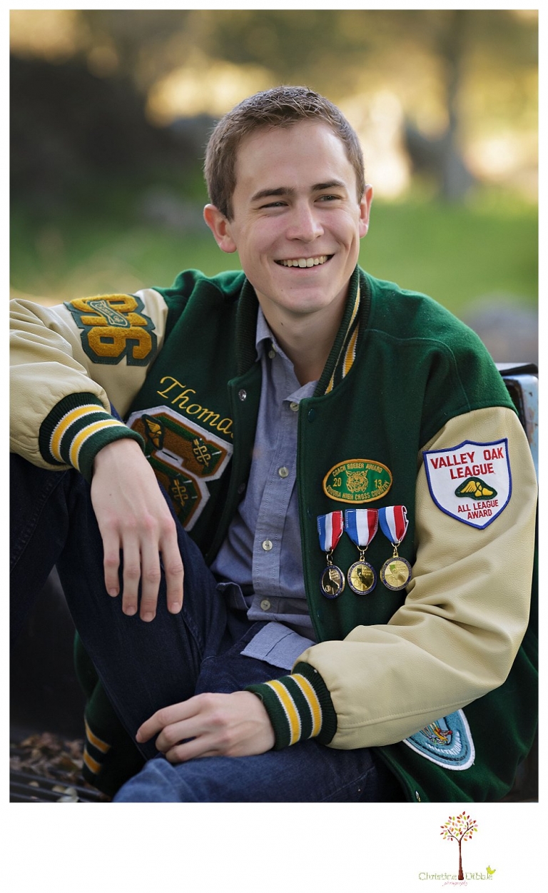 Sonora High senior portrait photographer Christine Dibble Photography takes outdoor spring senior portraits of a track star in his yard with his letterman jacket and old Chevy truck.
