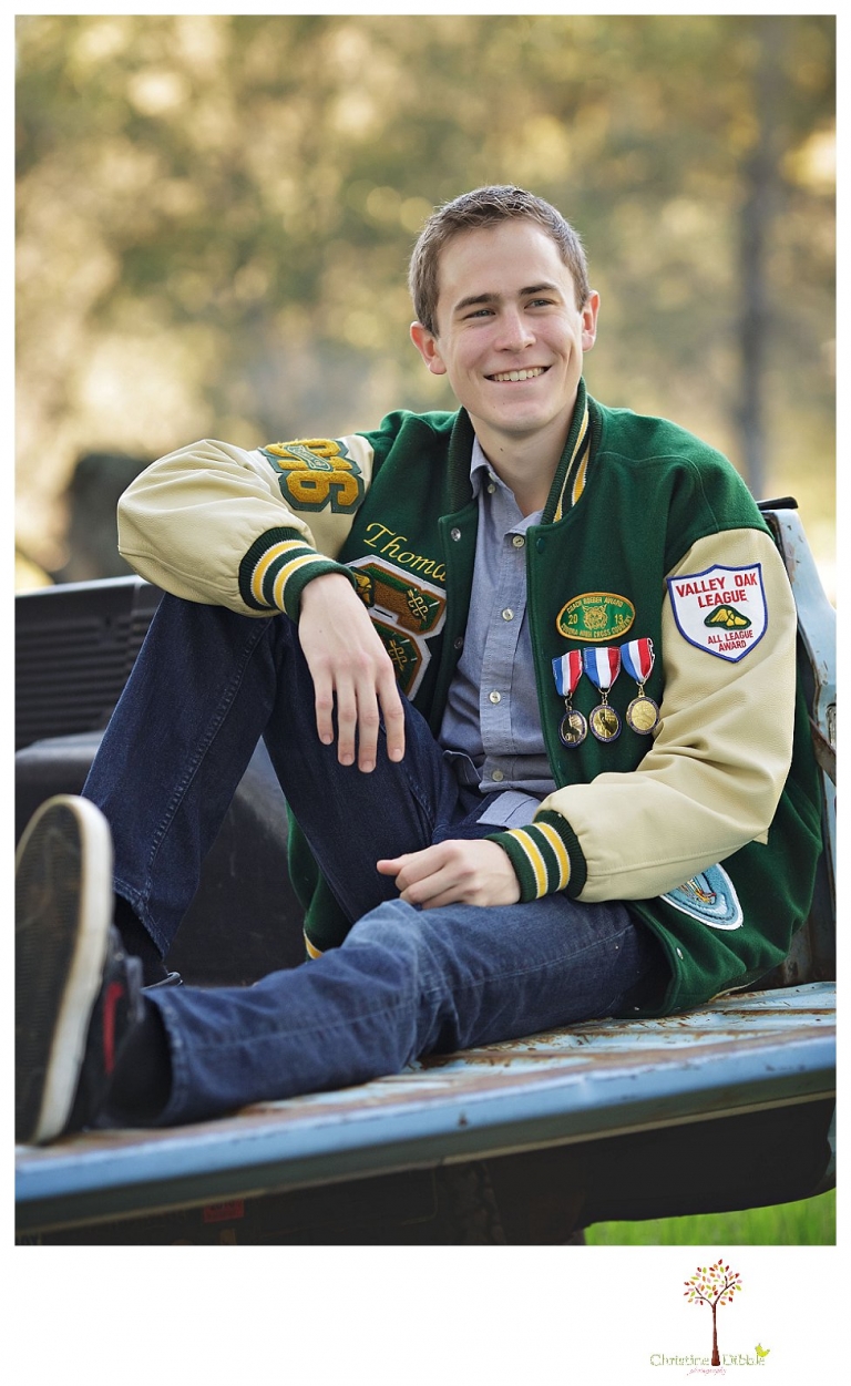 Sonora High senior portrait photographer Christine Dibble Photography takes outdoor spring senior portraits of a track star in his yard with his letterman jacket and old Chevy truck.