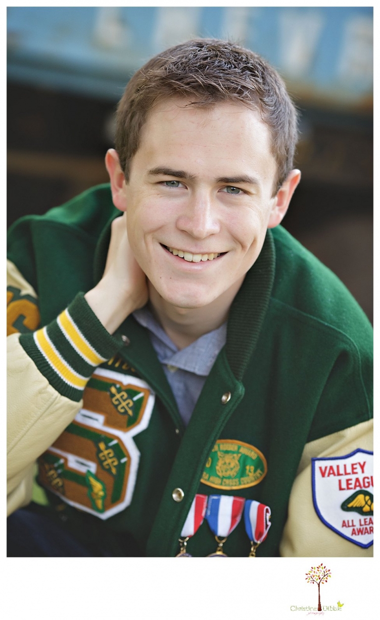 Sonora High senior portrait photographer Christine Dibble Photography takes outdoor spring senior portraits of a track star in his yard with his letterman jacket and old Chevy truck.