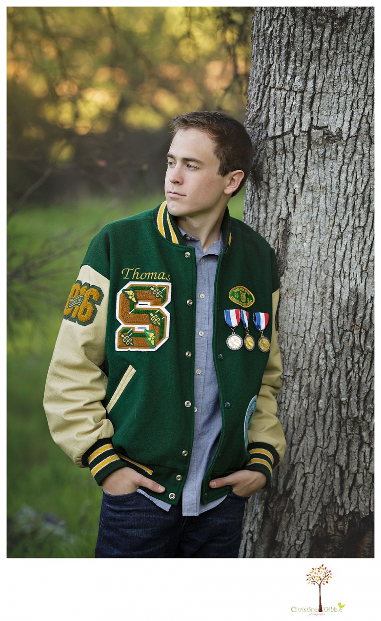 Sonora High senior portrait photographer Christine Dibble Photography takes outdoor spring senior portraits of a track star in his yard with his letterman jacket and old Chevy truck.