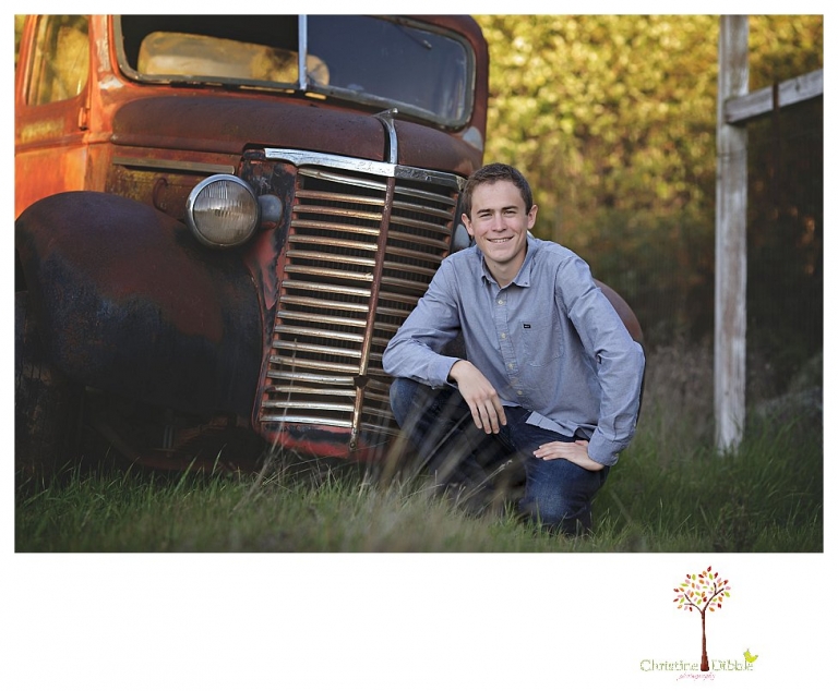 Sonora High senior portrait photographer Christine Dibble Photography takes outdoor spring senior portraits of a track star in his yard with his letterman jacket and old Chevy truck.