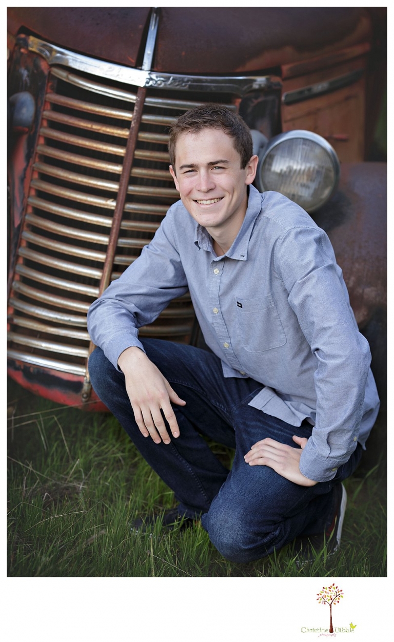 Sonora High senior portrait photographer Christine Dibble Photography takes outdoor spring senior portraits of a track star in his yard with his letterman jacket and old Chevy truck.