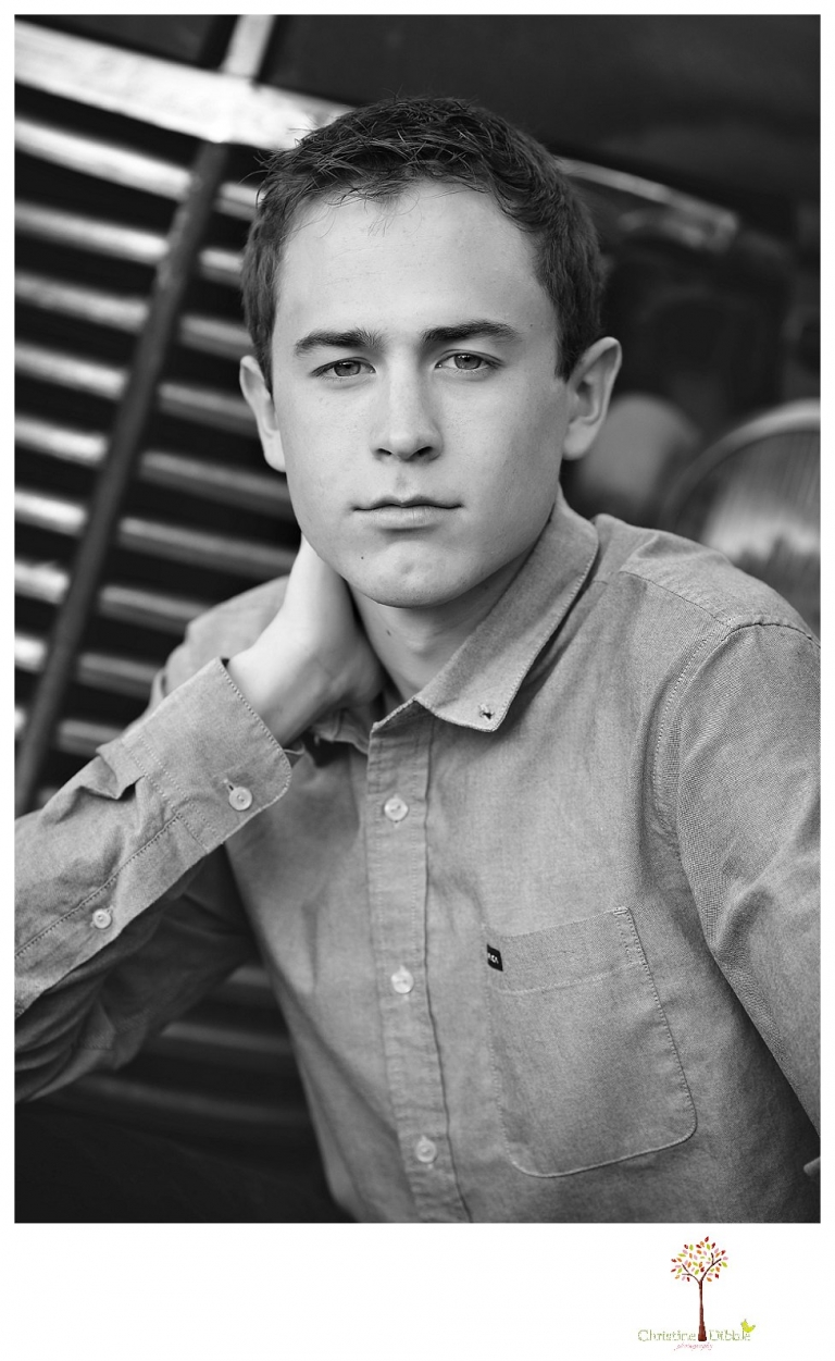Sonora High senior portrait photographer Christine Dibble Photography takes outdoor spring senior portraits of a track star in his yard with his letterman jacket and old Chevy truck.