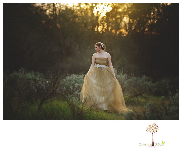 Sonora Summerville Senior Portrait photographer Christine Dibble Photography takes portraits of a senior girl in a full tulle dress among the blossoming trees at Bloomingcamp Ranch in Oakdale.
