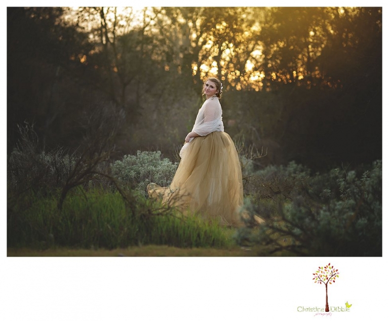 Sonora Summerville Senior Portrait photographer Christine Dibble Photography takes portraits of a senior girl in a full tulle dress among the blossoming trees at Bloomingcamp Ranch in Oakdale.