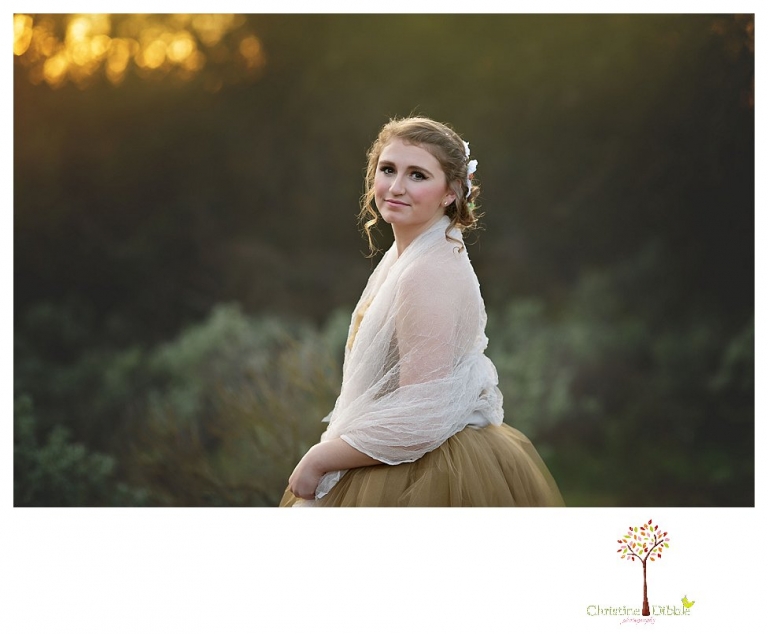 Sonora Summerville Senior Portrait photographer Christine Dibble Photography takes portraits of a senior girl in a full tulle dress among the blossoming trees at Bloomingcamp Ranch in Oakdale.