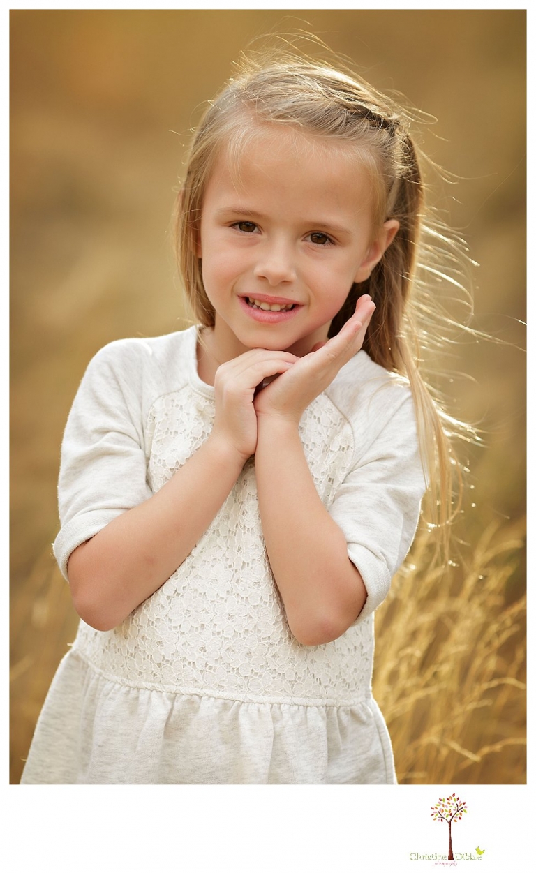 Sonora Family Photographer Christine Dibble Photography takes fall family portraits of a family with two little girls in both formal poses and while they hunt for ladybugs.
