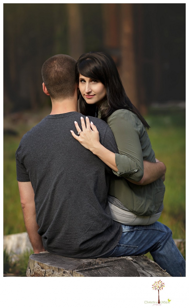 Sonora engagement and wedding photographer Christine Dibble Photography takes engagement photos of a couple in the woods at Pinecrest as they dance on a stump and walk through the trails. 