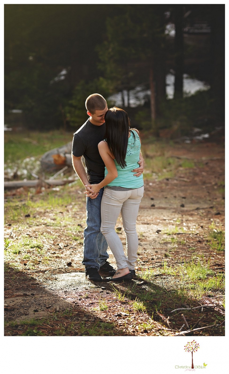 Sonora engagement and wedding photographer Christine Dibble Photography takes engagement photos of a couple in the woods at Pinecrest as they dance on a stump and walk through the trails. 