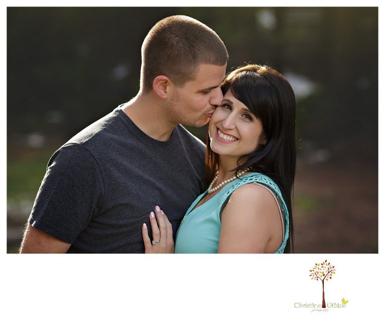 Sonora engagement and wedding photographer Christine Dibble Photography takes engagement photos of a couple in the woods at Pinecrest as they dance on a stump and walk through the trails. 