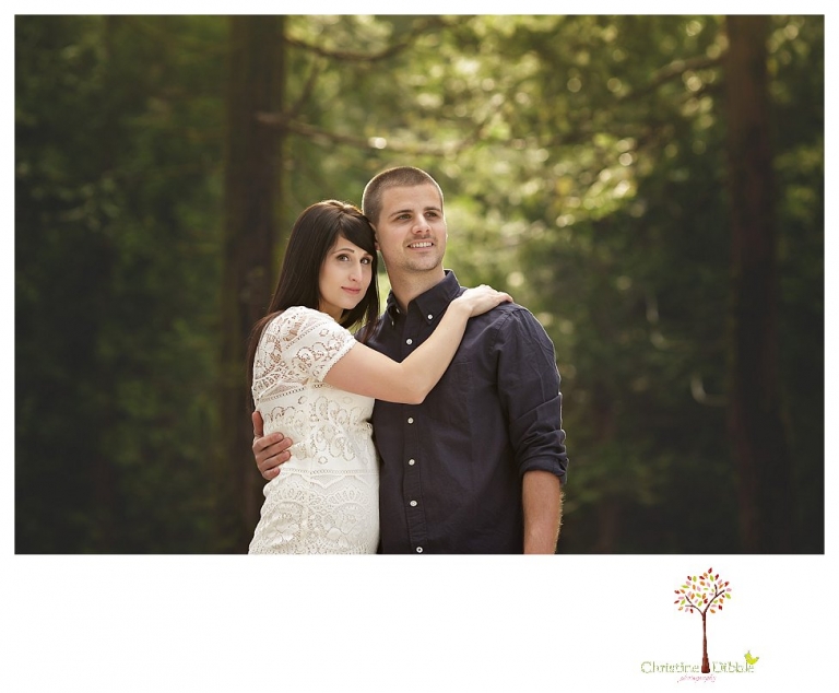 Sonora engagement and wedding photographer Christine Dibble Photography takes engagement photos of a couple in the woods at Pinecrest as they dance on a stump and walk through the trails. 