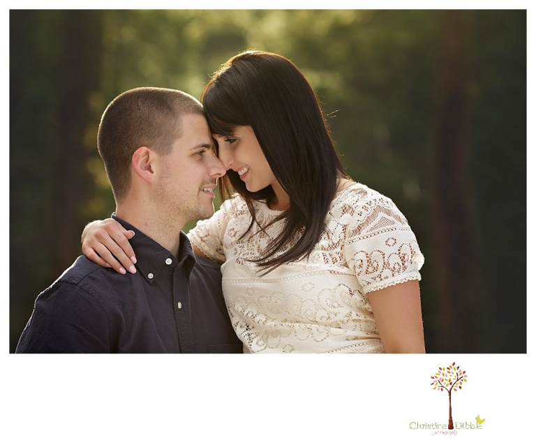 Sonora engagement and wedding photographer Christine Dibble Photography takes engagement photos of a couple in the woods at Pinecrest as they dance on a stump and walk through the trails. 