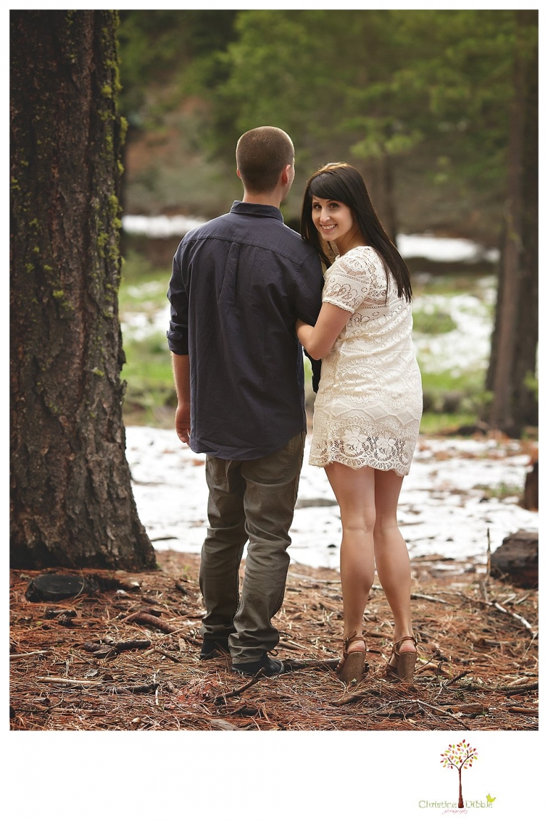 Sonora engagement and wedding photographer Christine Dibble Photography takes engagement photos of a couple in the woods at Pinecrest as they dance on a stump and walk through the trails. 