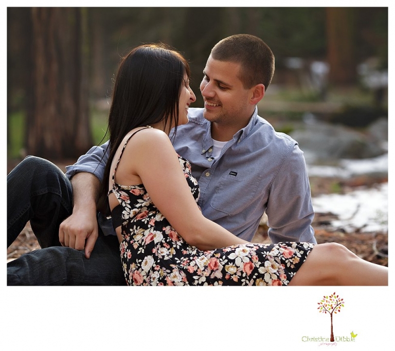 Sonora engagement and wedding photographer Christine Dibble Photography takes engagement photos of a couple in the woods at Pinecrest as they dance on a stump and walk through the trails. 
