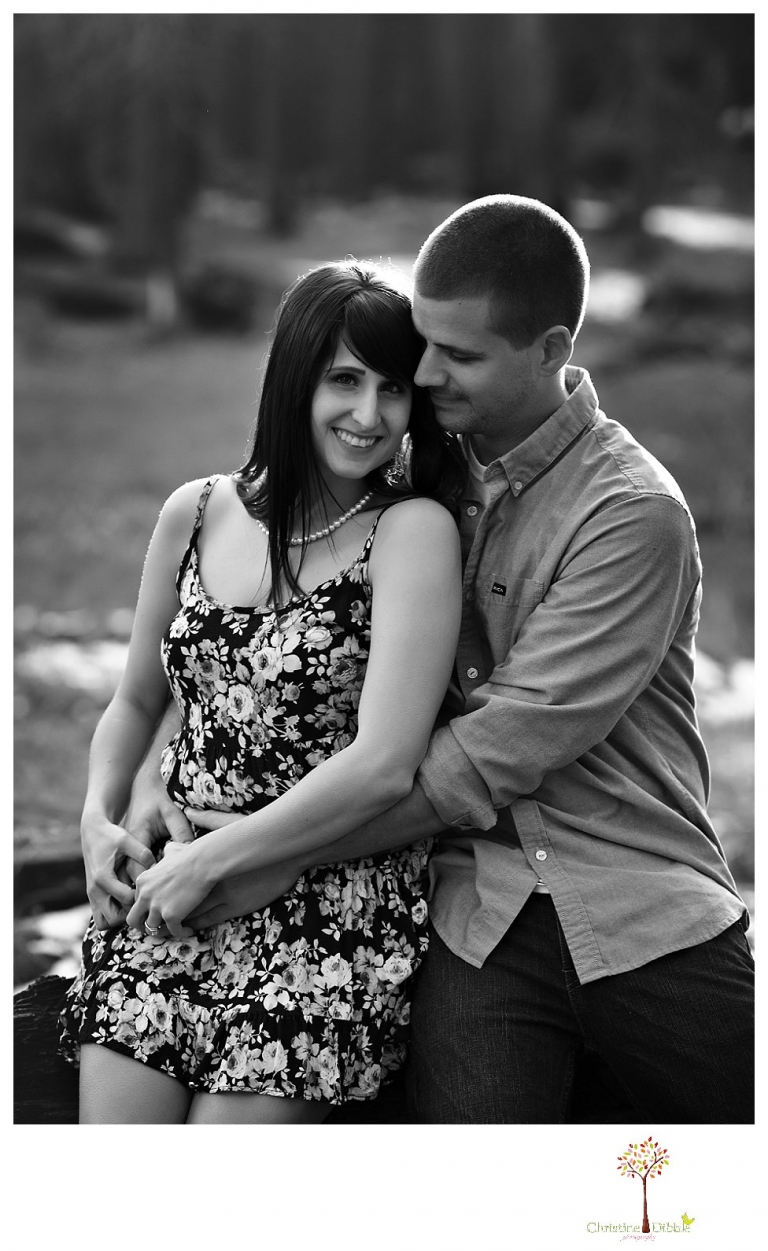 Sonora engagement and wedding photographer Christine Dibble Photography takes engagement photos of a couple in the woods at Pinecrest as they dance on a stump and walk through the trails. 