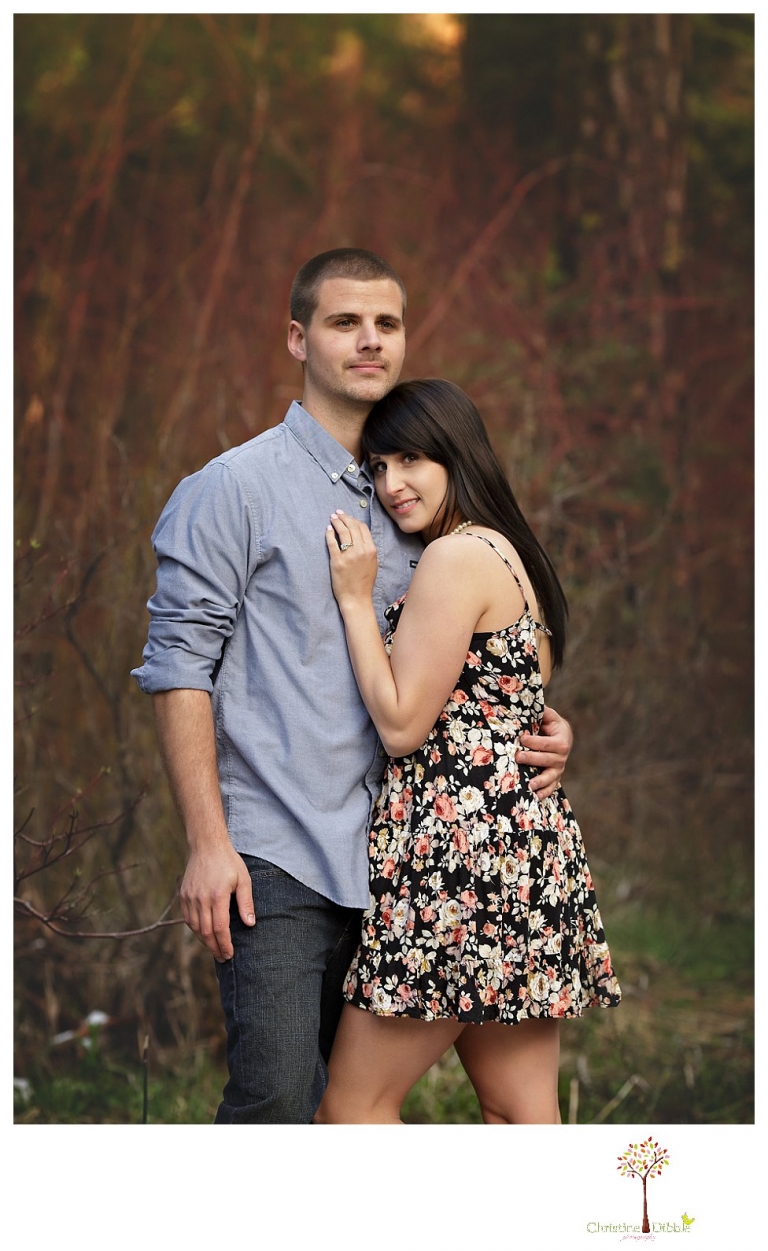 Sonora engagement and wedding photographer Christine Dibble Photography takes engagement photos of a couple in the woods at Pinecrest as they dance on a stump and walk through the trails. 