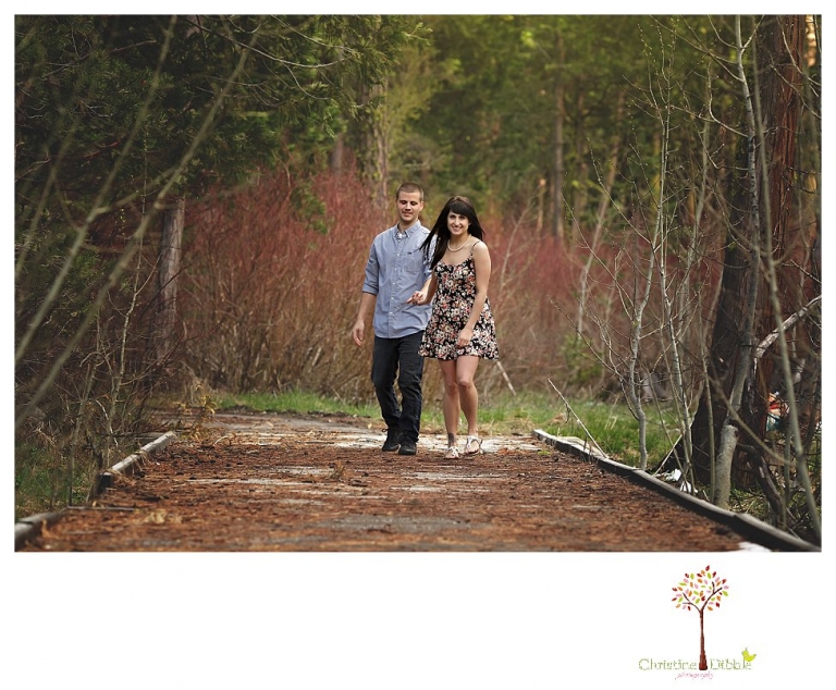 Sonora engagement and wedding photographer Christine Dibble Photography takes engagement photos of a couple in the woods at Pinecrest as they dance on a stump and walk through the trails. 