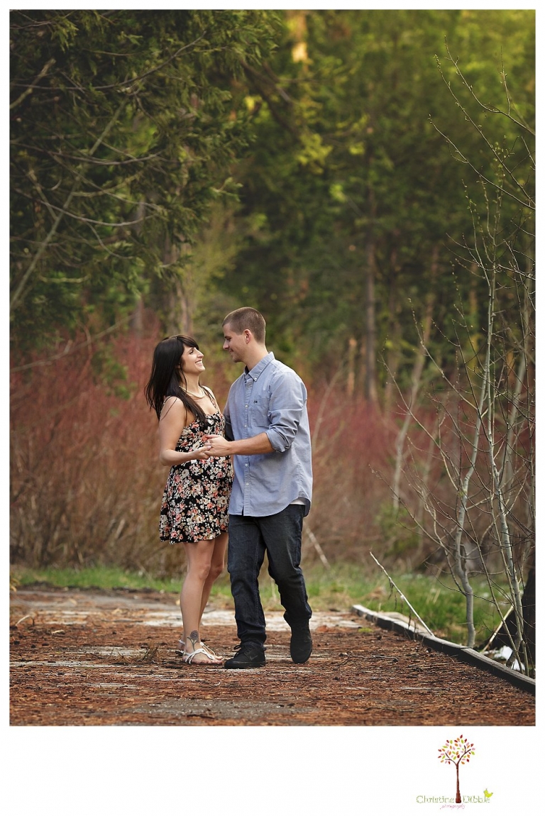 Sonora engagement and wedding photographer Christine Dibble Photography takes engagement photos of a couple in the woods at Pinecrest as they dance on a stump and walk through the trails. 