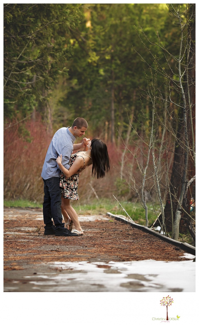 Sonora engagement and wedding photographer Christine Dibble Photography takes engagement photos of a couple in the woods at Pinecrest as they dance on a stump and walk through the trails. 