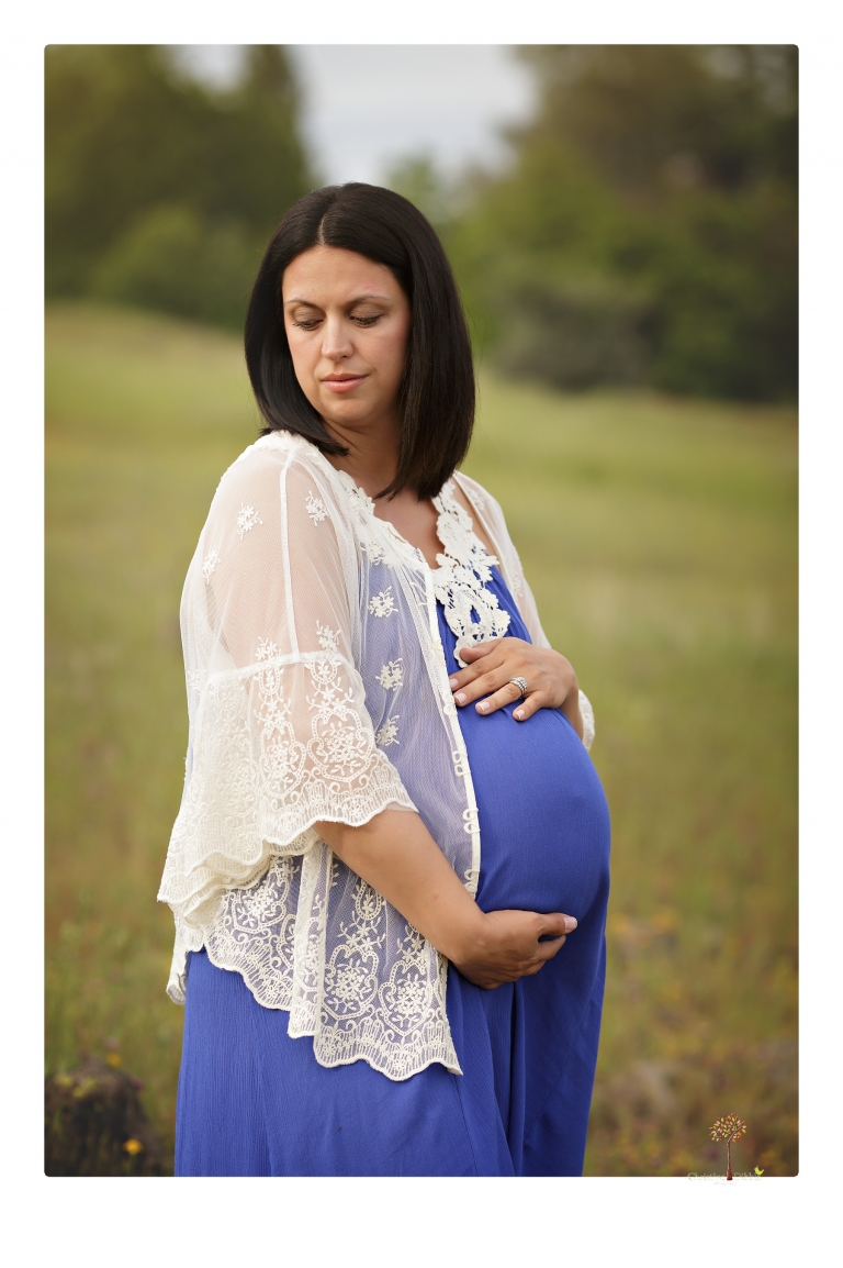 Sonora Maternity Photographer Christine Dibble Photography takes beautiful belly portraits of a mom-to-be pregnant with her fourth child in a blue dress and lace in a field of Lupine in Twain Harte.