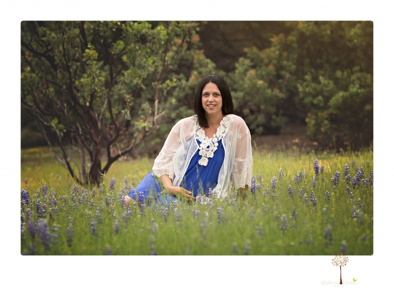 Sonora Maternity Photographer Christine Dibble Photography takes beautiful belly portraits of a mom-to-be pregnant with her fourth child in a blue dress and lace in a field of Lupine in Twain Harte.
