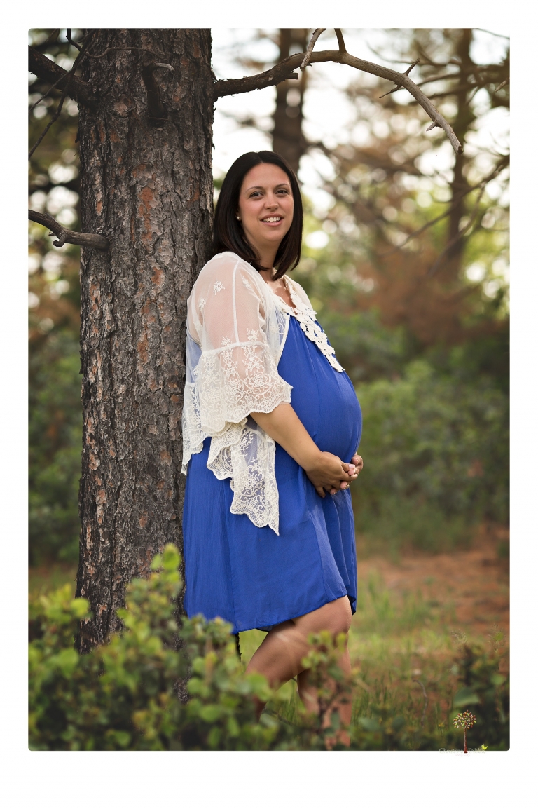 Sonora Maternity Photographer Christine Dibble Photography takes beautiful belly portraits of a mom-to-be pregnant with her fourth child in a blue dress and lace in a field of Lupine in Twain Harte.